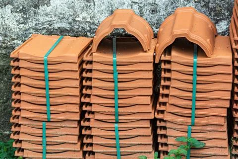 Ceramic roof shingles on a stack on a construction site. Stock Photos