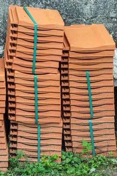 Ceramic roof shingles on a stack on a construction site on a bright suunny da Stock Photos