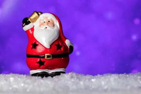 Ceramic Santa Claus statue standing on snow Stock Photos