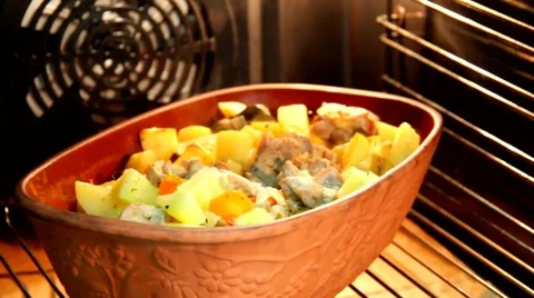 Ceramic sauce pot with stew meat in oven Stock Footage 43428686