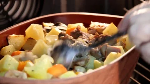 Ceramic sauce pot with stew meat in oven Stock Footage 43429342