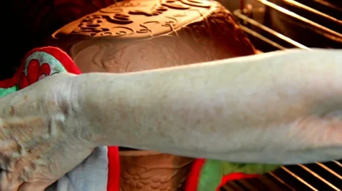 Ceramic sauce pot with stew meat in oven Stock Footage 43429457