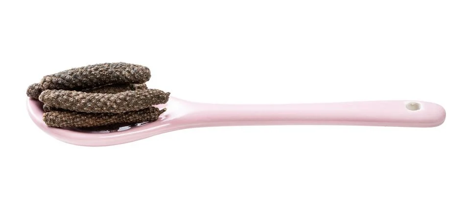 Ceramic spoon with java long peppers isolated Photos