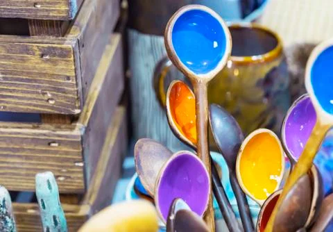 Ceramic spoons in a rustic style with a colored middle. Stock Photos