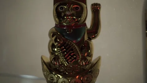 A ceramic statuette of a cat is on a table Stock Footage 77022845