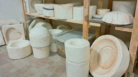 A ceramic studio interior showcasing numerous plaster molds and casting forms 스톡 사진