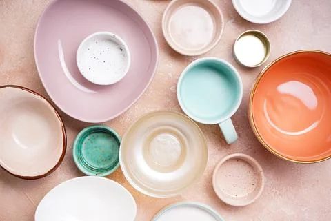 Ceramic tableware on beige background, top view. Stock Photos