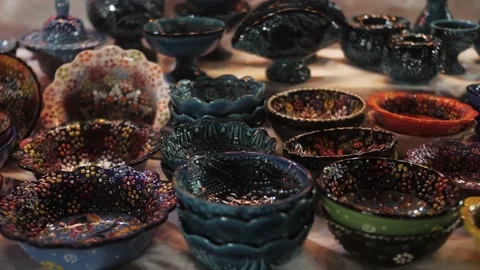 Ceramic tableware close up at the oriental market. Colorful bowls at bazaar Stock Footage 217779965