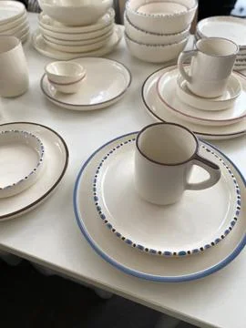 Ceramic tableware with minimalist design on display, featuring plates, bowl.. Stock Photos