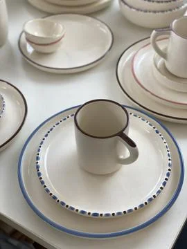 Ceramic tableware set with plates and mug featuring simple pattern, suitabl.. Stock Photos