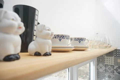 Ceramic tableware on the shelf in the kitchen Stock Photos