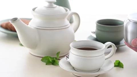 Ceramic Tea Set White and Olive Green Teapot Mugs on Tabletop 4K 動画素材 339268053