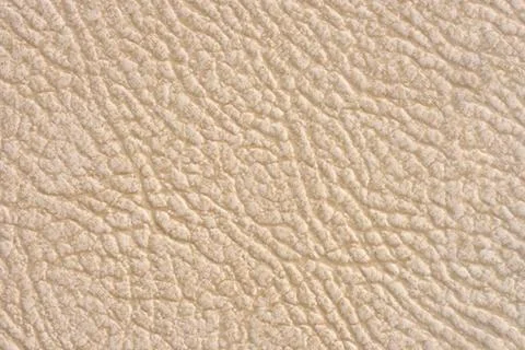 Ceramic tile beige leather effect background. Closeup texture Stock Photos