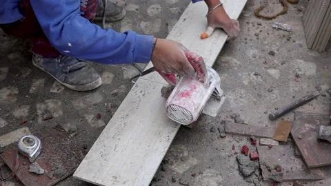 Ceramic tile is being cut by tile cutting machine and sparks coming out Stock Footage 168171322