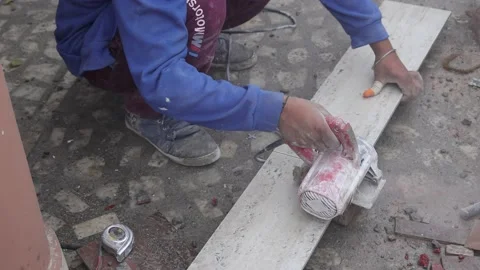 Ceramic tile is being cut by tile cutting machine and sparks coming out Stock Footage 168171564