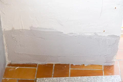 Ceramic tile installation site with its tools Stock Photos