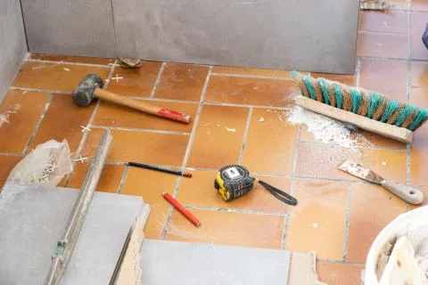 Ceramic tile installation site with its tools Stock Photos