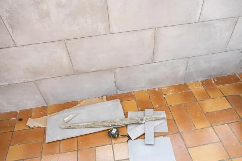 Ceramic tile installation site with its tools Stock Photos