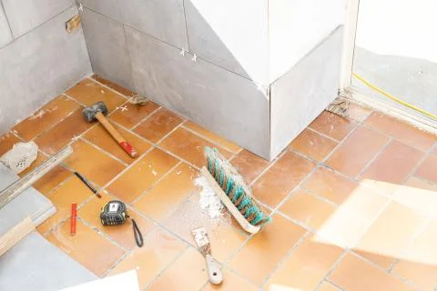 Ceramic tile installation site with its tools Stock Photos