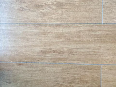 Ceramic tile with a pattern under the parquet Stock Photos