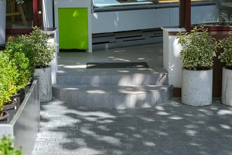 Ceramic tile round threshold doorstep store entrance with door mat. Stock Photos