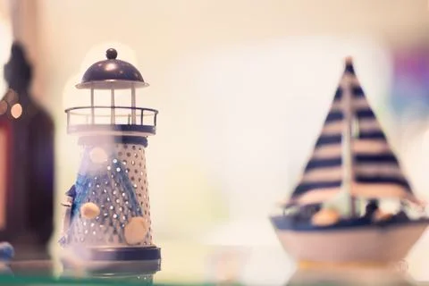 A ceramic tower decorated with seashells and a ceramic sailboat. home decor.. Stock Photos
