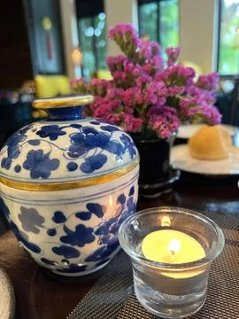 Ceramic vase and candle on a table in a restaurant Stock Photos