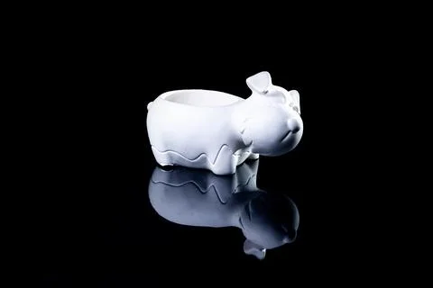 Ceramic vase in the form of a dog with reflection, black background isolated, Stock Photos
