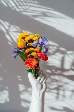 Ceramic Vase made in the shape of human hand with multicolor various summer Stock Photos