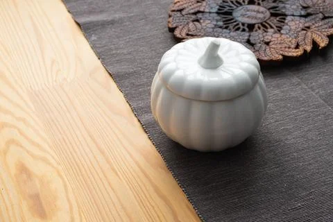 Ceramic vase in the shape of a pumpkin on the table. Kitchen decor Stock Photos