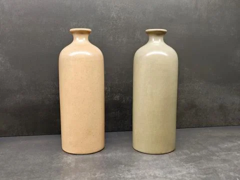 Ceramic vases display. Two matte ceramic vessels positioned on table with s.. Stock Photos