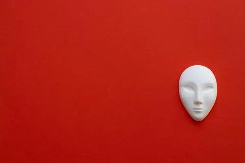 Ceramic white mask on red background Stock Photos