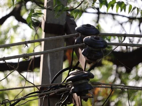 A ceramic winding insulator placed on the electrical pole for the power supply. Stock Photos