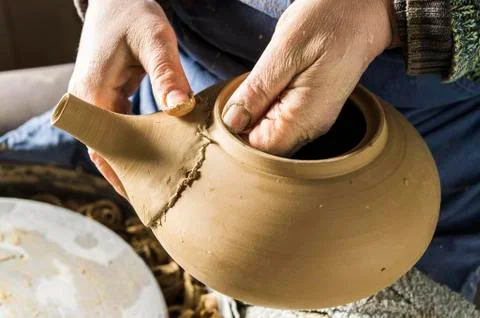 Ceramic workshop hands checking fit of spout on pot Pittenhart Upper Bavaria Stock Photos