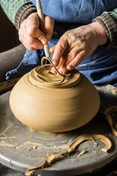 Ceramic workshop hands shape bottom of pot on pottery wheel Pittenhart Upper Stock Photos
