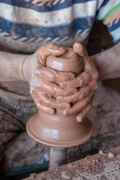 Ceramic workshop - the man  makes a pot of clay on a potter's wheel Stock Photos