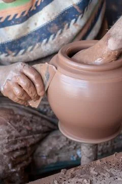 Ceramic workshop - the man  makes a pot of clay on a potter's wheel Stock Photos