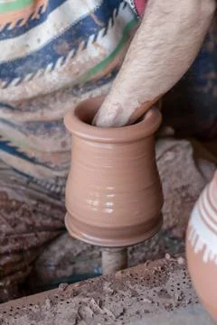 Ceramic workshop - the man  makes a pot of clay on a potter's wheel Stock Photos