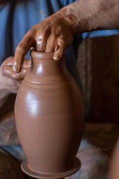Ceramic workshop - the man  makes a pot of clay on a potter's wheel Stock Photos