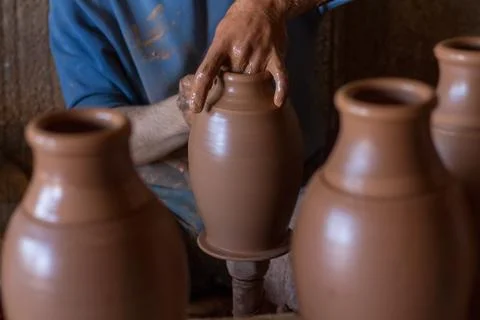 Ceramic workshop - the man  makes a pot of clay on a potter's wheel Stock Photos