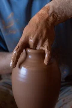 Ceramic workshop - the man  makes a pot of clay on a potter's wheel Stock Photos