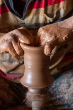 Ceramic workshop - the man  makes a pot of clay on a potter's wheel Stock Photos
