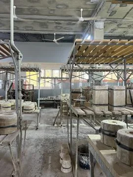 Ceramic workshop showcases tools and tables filled with clay pieces awaiting  Stock Photos