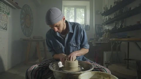 Ceramicist man at work with clay on the potter's wheel. Stock Footage 251528128