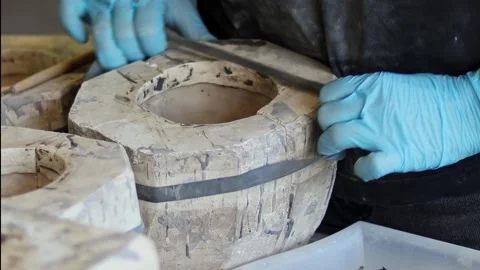 A ceramist assembles plaster molds for slip casting ceramic products Stock Footage 275114788