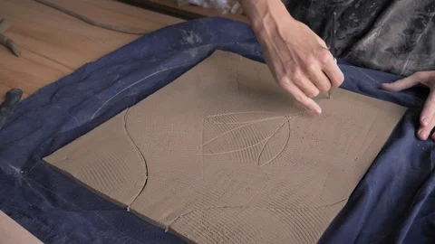 Ceramist creates a pattern and relief dolly shot Stock Footage 104870362