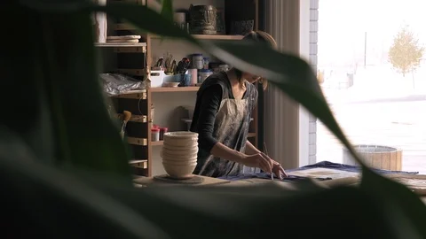 Ceramist creates a pattern and relief dolly shot Stock Footage 104870815
