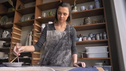 Ceramist creates a pattern and relief dolly shot Stock Footage 104871020