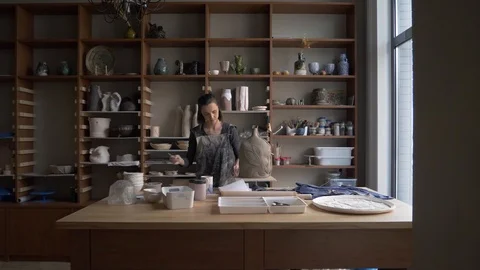 Ceramist creates a pattern and relief dolly shot Stock Footage 104871366