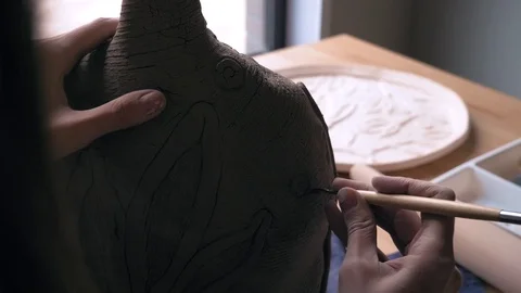 Ceramist creates a pattern and relief dolly shot Stock Footage 104871937